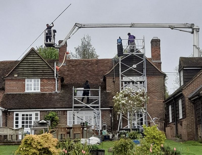The Roof Moss Cleaners using cherry picker and scaffolding to clean roof safely and professionally in Billingshurst, West Sussex